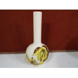 Moorcroft Pottery - A Moorcroft pottery bud vase decorated with the Leaves in the Wind pattern on a