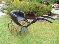 A Victorian doll's push pram with 32 cm (diameter) spoked wheels This lot MUST be paid for and