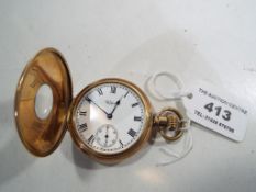 A gentlemans hunter-style pocket watch by Waltham in a gold plated Dennison case,