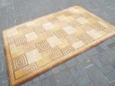 A good quality hand made wool rug with geometric pattern measuring approximately 160 cm x 244 cm.