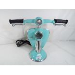 An unusual turquoise lamp in the form of a Lambretta scooter, 28 cm (h).