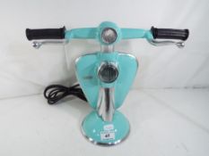 An unusual turquoise lamp in the form of a Lambretta scooter, 28 cm (h).