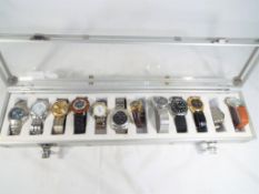 A display case containing twelve watches to include Rotary, Timex, Sekonda,