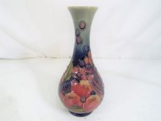 Moorcroft Pottery - A Moorcroft pottery bud vase decorated in the finches and fruit pattern,