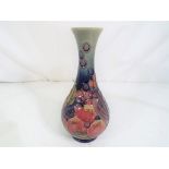 Moorcroft Pottery - A Moorcroft pottery bud vase decorated in the finches and fruit pattern,