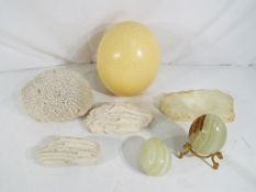 A mixed lot to include an ostrich egg, coral / sponge samples, onyx eggs and similar.