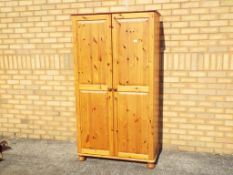 A pine double wardrobe, approximately 174 cm x 96 cm x 52 cm.