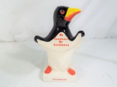 Carlton Ware - a Carlton Ware Guinness penguin lamp base, approximate height 18 cm (h).