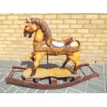 Rocking horse - a unusual highly carved hand painted wooden rocking horse with braided horsehair