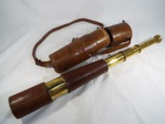 A good quality brass telescopic telescope with leather carry case marked T.
