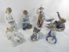 Nao - seven figurines by Nao predominantly children,