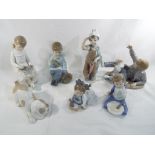 Nao - seven figurines by Nao predominantly children,