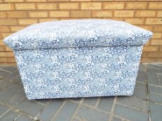 An upholstered linen chest with hinged lid,