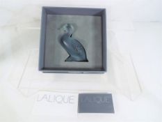 A Lalique paperweight in the form of a duck, with ephemera, boxed.