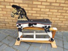 A wooden hand-painted rocking horse, app