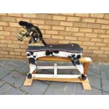 A wooden hand-painted rocking horse, app