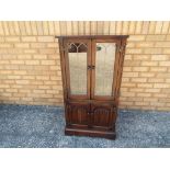 A Nathan oak linen fronted two door cabi