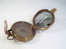 A brass compass marked T. Cooke & Sons.