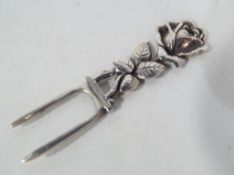 A silver pickle fork stamped 800 and dec
