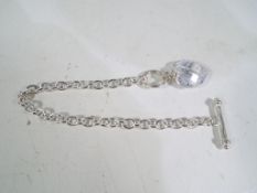 A silver bracelet with glass pendant and