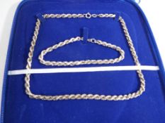 A silver rope chain, matching bracelet a