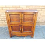 A mahogany four door cabinet with hinged