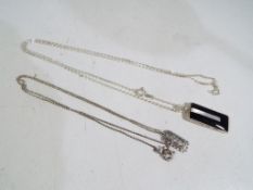 Two silver necklaces with pendants. Esti