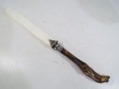 A letter opener with silver mount and an