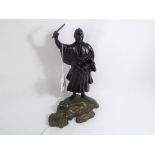 An Oriental hand-painted cast figure depicting a Samurai warrior, approximate height 24 cm (h).