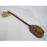 Tribal Art - a tribal musical string instrument made with a tortoise shell on a carved wooden