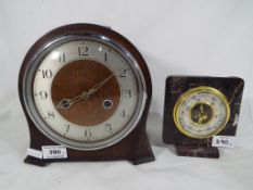 An oak cased Smiths Enfield mantel, clock Arabic numerals to the dial,