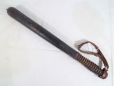 A good quality turned wooden truncheon with leather strap, approx.