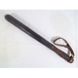 A good quality turned wooden truncheon with leather strap, approx.