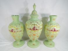 Three large hand painted milk glass vases, one with cover,