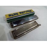 A M Hohner - A Super Chromonica harmonica by M. Hohner and a Blue Rhythm harmonica in original box.