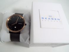 A Skagen gentleman's wristwatch with calendar, with black metal strap in original presentation box.