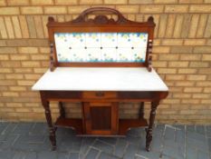 A mahogany marble topped tiled back wash stand,