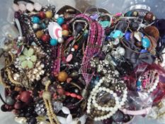 A box of mixed costume jewellery to include bangles, earrings and necklaces,