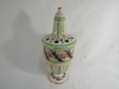A good quality hand painted ceramic lidded pot pourri pot decorated with a floral pattern on a