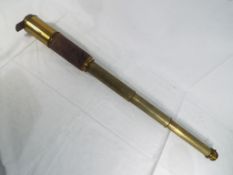 A brass and leather clad 3 draw telescope,