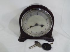 A Bakelite cased mantel clock by Enfield with pendulum and key Est £20 to £30 This lot MUST be paid