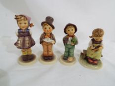Four Goebel Hummel figurines.