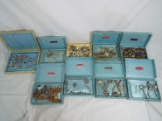 9 boxes containing a quantity of vintage costume jewellery This lot MUST be paid for and collected,