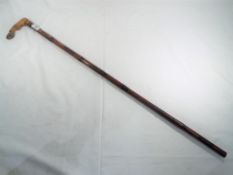 A good quality carved walking stick with handle depicting an animal hoof.