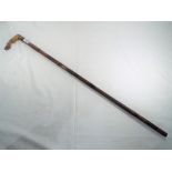A good quality carved walking stick with handle depicting an animal hoof.