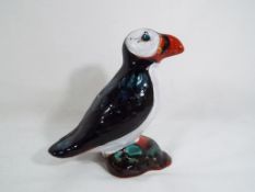 Anita Harris - an Anita Harris figurine depicting a puffin, signed by the artist in gold,