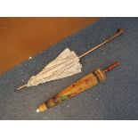 Two parasols, the larger a vintage example with wooden handle, white metal ferrule,