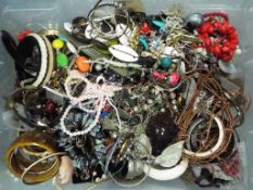 A box of mixed costume jewellery to include bangles, necklaces and similar,