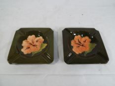 Moorcroft pottery - Two square ashtrays by Moorcroft pottery decorated with Coral Hibiscus on a