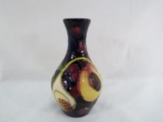 Moorcroft - a Moorcroft vase decorated in the Queen's Choice pattern, approximate height 14 cm (h).